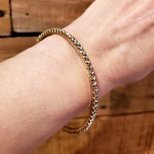Delicate goldtone and rhinestone bangle